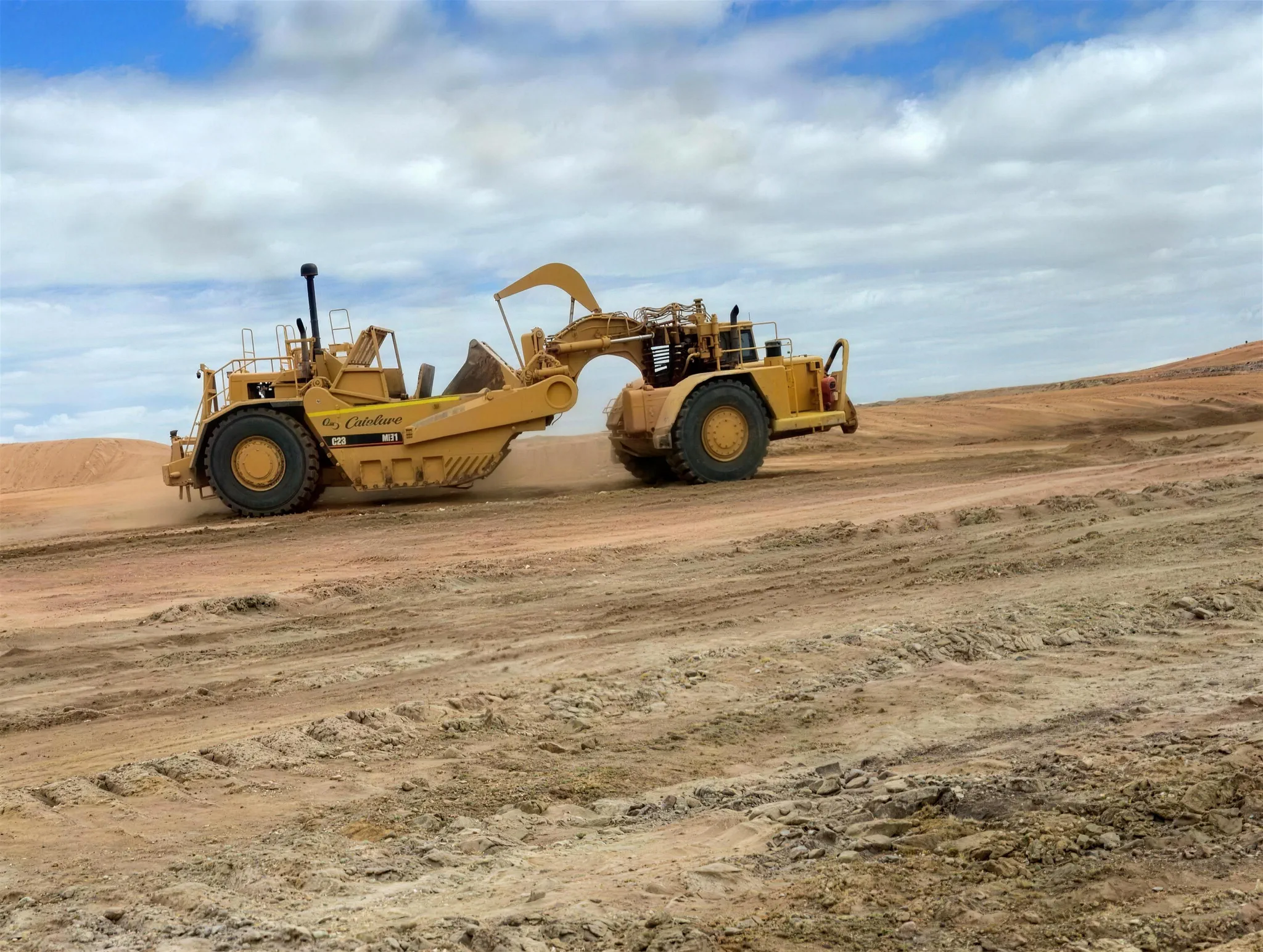 CAT motor scraper cutting bulk earthworks on a Western Australian job