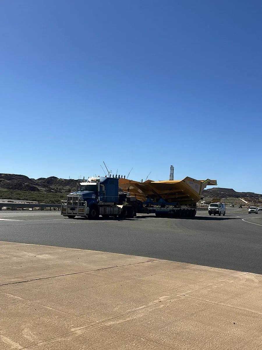 Road train hauling an oversize dump truck body in the Pilbara